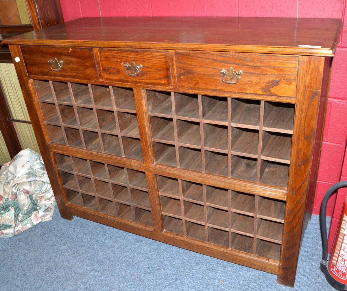 Lot 1401 - Reproduction oak bottle rack with three drawers