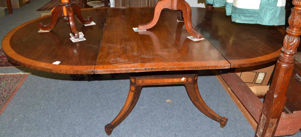 Lot 1410 - A 19th century rosewood and satinwood banded dining table with one extra leaf