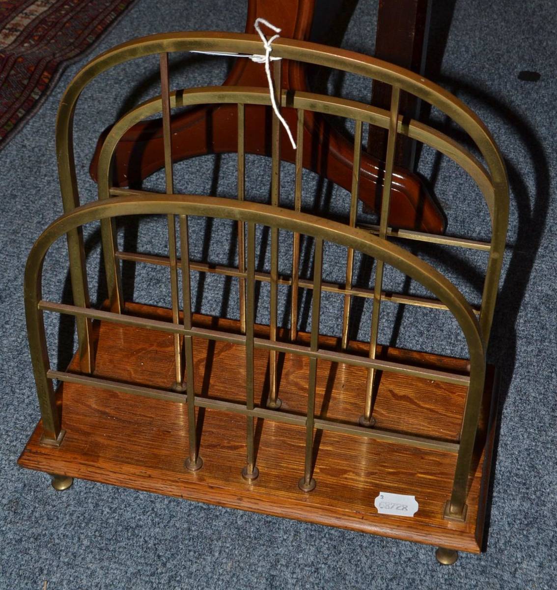 Lot 1432 - An Edwardian brass magazine rack