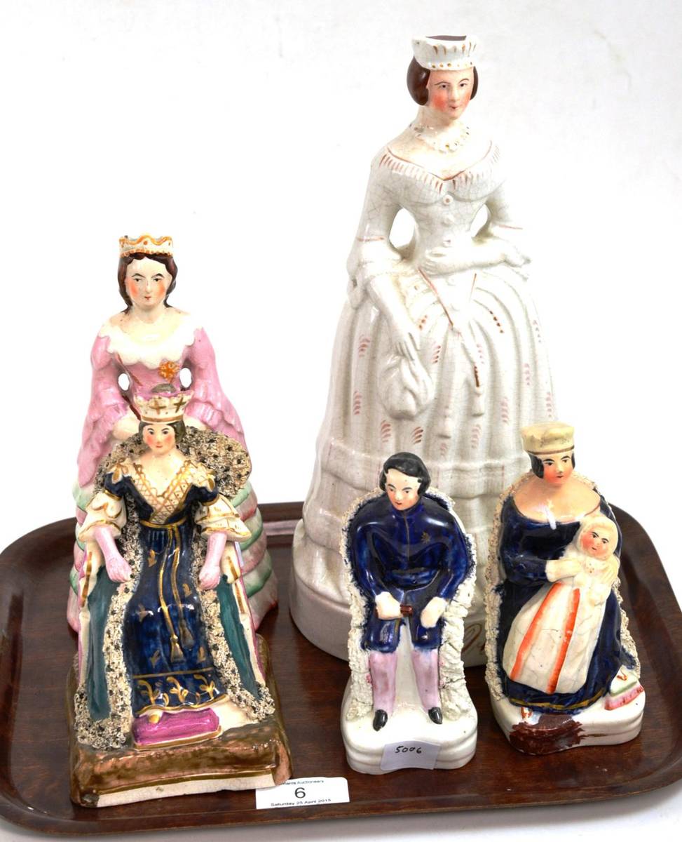 Lot 6 - A Staffordshire pottery figure of Queen Victoria, circa 1840, in ceremonial robes sitting in a...