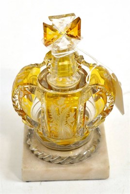 Lot 12 - A Bohemian amber flashed scent bottle and stopper, circa 1880, modelled as a crown engraved...