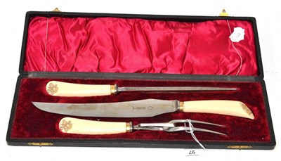 Lot 97 - Three piece carving set, circa 1890, the ivory handles set with gilt crowned V R monogram, cased