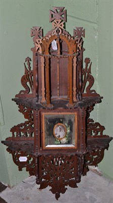 Lot 101 - A Diamond Jubilee fret carved hanging wall cupboard, 1897, the mirrored door with a bust...