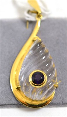 Lot 225 - An 18ct gold rock crystal and amethyst pendant, a teardrop carved rock crystal within a yellow...