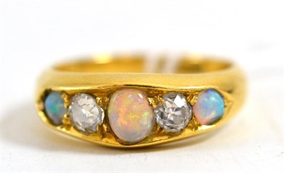 Lot 226 - An opal and diamond five stone ring, circa 1880, the graduated oval cabochon opals alternate...