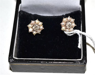 Lot 230 - A pair of diamond and split pearl earrings, an old cut diamond within a border of split pearls,...