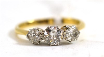 Lot 240 - A three stone diamond ring, the graduated old cut diamonds in white claw settings, to a yellow...