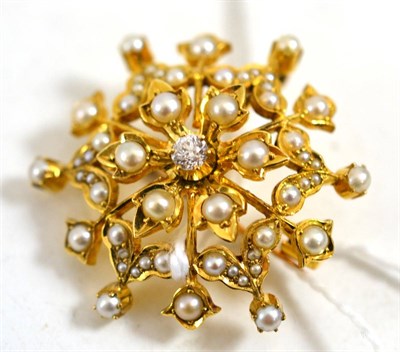 Lot 251 - A pearl and diamond brooch/pendant, circa 1900, an old cut diamond centres the star motif inset...