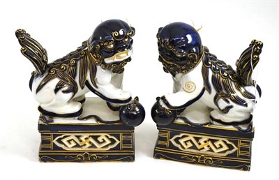 Lot 267 - Pair of 1875 Royal Worcester Buddhistic lion candlesticks, 24cm high