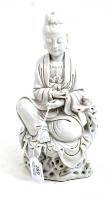 Lot 289 - A Blanc de Chine figure of Guanyin, Qing Dynasty, sitting on a root work throne, impressed...