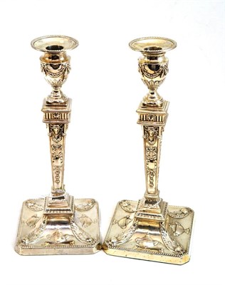 Lot 302 - A matched pair of Neo Classical style silver candlesticks decorated with typical rams' heads...