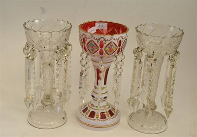 Lot 313 - A Bohemian white overlay ruby glass table lustre with flower painted decoration and prismatic...