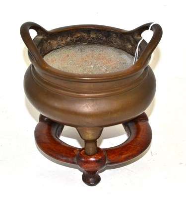 Lot 324 - A Chinese bronze censer on three feet with loop handles, bears six character reign mark, 16.5cm...