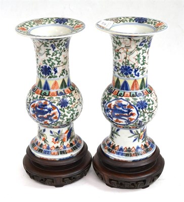 Lot 327 - A pair of Chinese Wucai porcelain vases, Wanli reign marks but probably later, painted with dragons