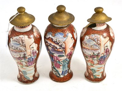 Lot 337 - A set of three Chinese porcelain baluster vases, Qianlong, painted in famille rose enamels with...