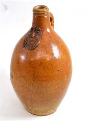 Lot 340 - A stoneware bottle, 17th century, later applied with a mask, 26.5cm high