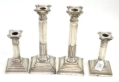 Lot 342 - Two pairs of silver candlesticks