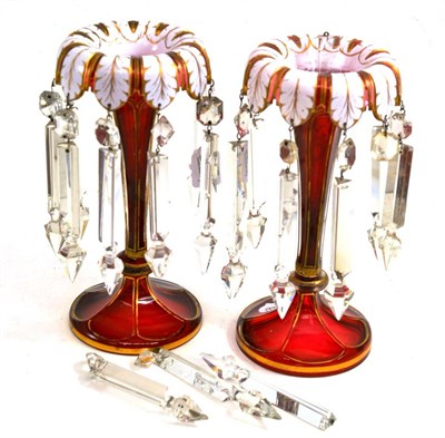 Lot 343 - A pair of Bohemian white overlay ruby glass lustres, circa 1860, with leaf borders and spear drops