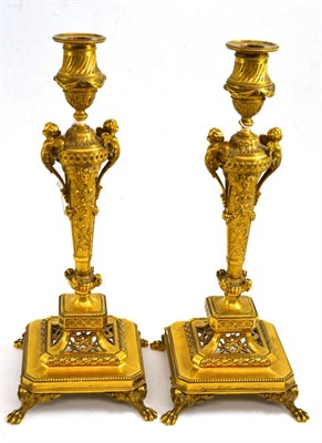 Lot 344 - Pair of late 19th century gilt bronze candlesticks on paw feet, with nozzles, 37cm high