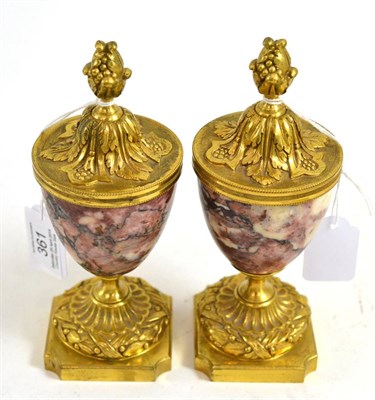 Lot 361 - Pair of small 19th century urns in breche violette marble and gilt bronze