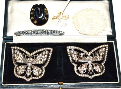 Lot 386 - A jet horseshoe brooch, two paste set butterfly buckles/panels and a paste brooch (4)