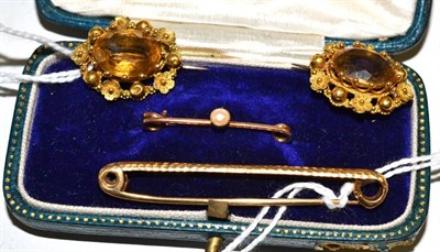 Lot 407 - Four brooches and pins, including two citrine brooches within floral and bead decorated frames...