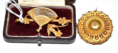 Lot 409 - Two brooches including a round Victorian brooch with a central rose cut diamond, 3.6cm in diameter