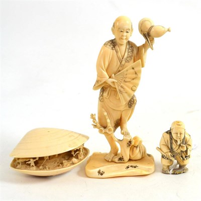 Lot 421 - A Japanese ivory okimono, depicting a gentleman holding a fan and standing on one foot, ivory shell