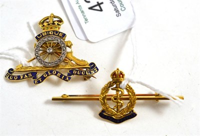 Lot 425 - Medical care brooch, stamped '14CT' and a Royal Artillery brooch (2)