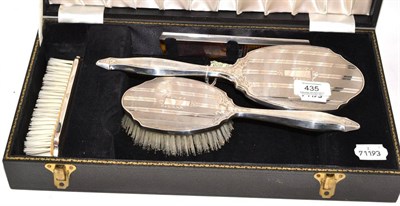 Lot 435 - A four piece cased silver dressing table set