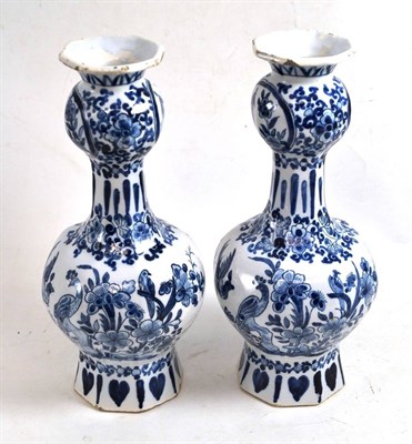 Lot 453 - A pair of Delft vases in 18th century style, of panelled baluster form and decorated with birds...