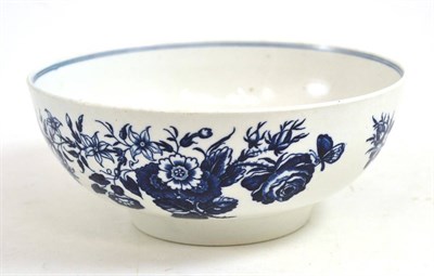 Lot 460 - A First Period Worcester porcelain bowl, circa 1775, printed underglaze blue with three flowers...