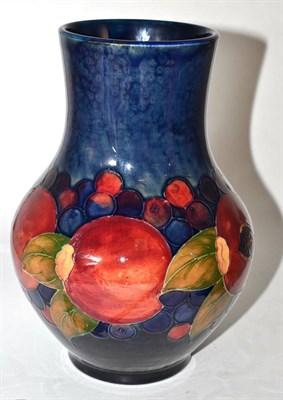 Lot 461 - A William Moorcroft Pomegranate pattern vase, on a blue ground, impressed facsimile signature...