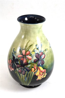 Lot 468 - A Walter Moorcroft Spring Flowers pattern vase, on a blue/green wash ground, impressed factory...