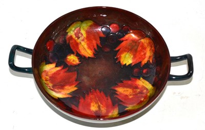 Lot 473 - A William/Walter Moorcroft flambe leaf and grape pattern twin-handled pedestal dish, impressed...