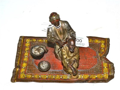 Lot 500 - Cold painted bronze of an Arab cutting hair