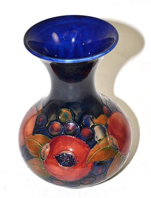 Lot 515 - A William Moorcroft Pomegranate pattern vase, on a blue ground, impressed factory marks and...