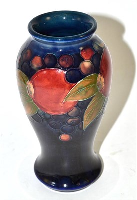 Lot 519 - A William Moorcroft Pomegranate pattern baluster vase, on a blue ground, impressed factory...