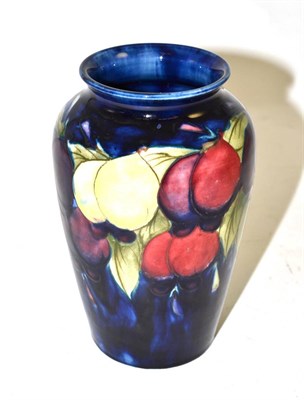 Lot 526 - A William Moorcroft Wisteria pattern vase, on a blue ground, impressed factory marks and blue...