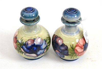 Lot 527 - Two Walter Moorcroft Anemone pattern globular scent bottles and stoppers, both with impressed...