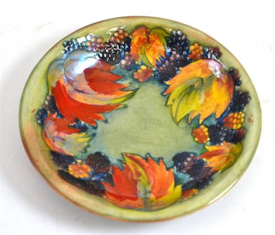 Lot 528 - A William Moorcroft Leaf and Berry pattern dish, on a green/blue wash ground, impressed factory...