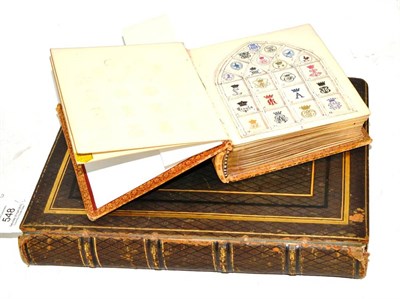 Lot 548 - Two albums of family crests decoratively displayed, leather bindings (2)