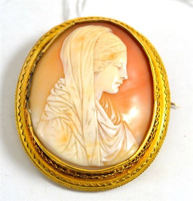 Lot 581 - A cameo brooch, depicting a lady wearing a shawl, with rope twist decorated frame (a.f.),...