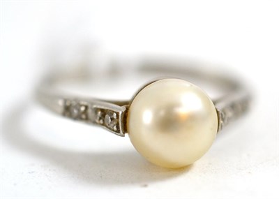 Lot 583 - A pearl and diamond ring, the pearl between shoulders set with single-cut diamonds, to a plain...