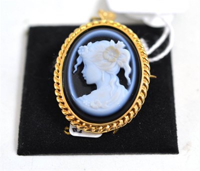 Lot 590 - A 9ct gold cameo brooch/pendant, the onyx carved to depict a maiden with flowers in her hair,...