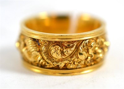 Lot 591 - An 18ct gold mourning ring, heavily decorated with a scrolling and foliate design, engraved to...