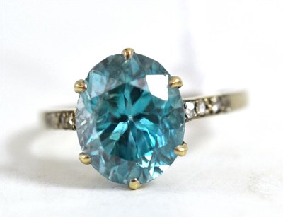 Lot 593 - A blue zircon and diamond ring, mid 20th century, the oval cut zircon in a white claw setting, with