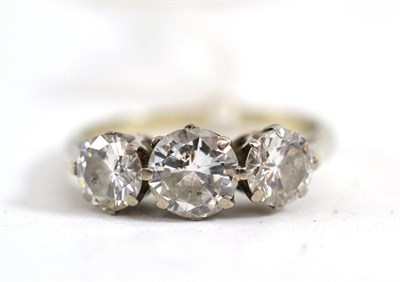 Lot 595 - A diamond three stone ring, the graduated round brilliant cut diamonds in a white claw setting,...