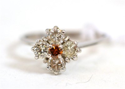 Lot 610 - A diamond cluster ring, an orangey-brown round brilliant cut diamond within a frame of four...