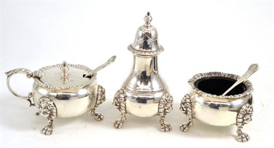 Lot 613 - Three piece silver condiment set of large proportions, with two spoons